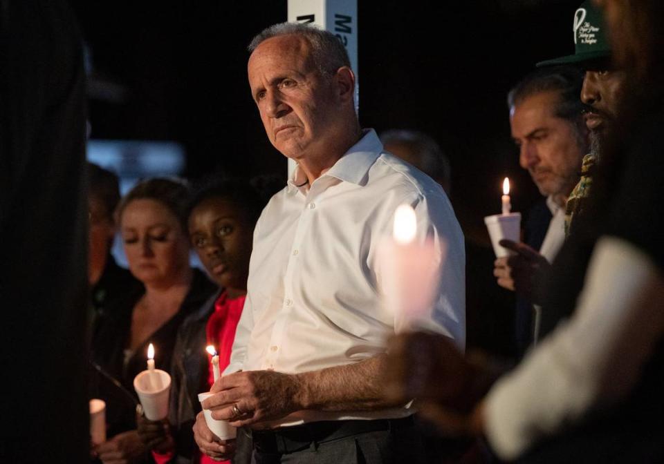 Sacramento Mayor Darrell Steinberg, left, and community activist Berry Accius, founder of Sacramento’s Voice of the Youth and other community members hold a vigil at Ali Youssefi Square in Sacramento on April 4.