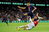 Soccer Football - Ligue 1 - Paris St Germain v AS Monaco - Parc des Princes, Paris, France - April 21, 2019 Paris St Germain's Kylian Mbappe in action with AS Monaco's Kamil Glik REUTERS/Gonzalo Fuentes