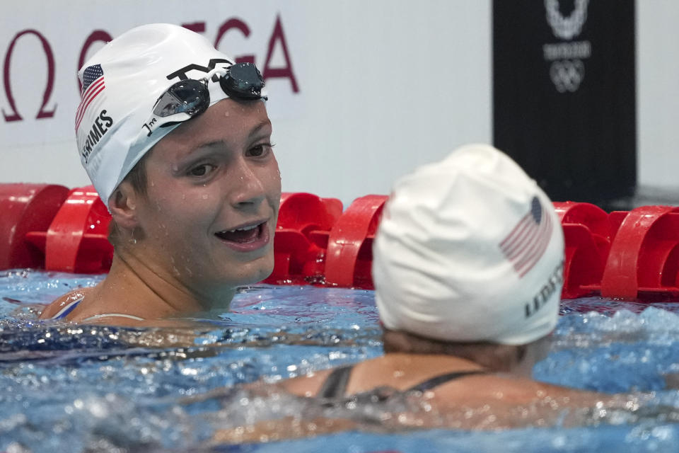 Katie Grimes, left, of the United States, talks with teammate Katie Ledecky, following their heat of the women's 800-meter freestyle at the 2020 Summer Olympics, Thursday, July 29, 2021, in Tokyo, Japan. (AP Photo/Matthias Schrader)