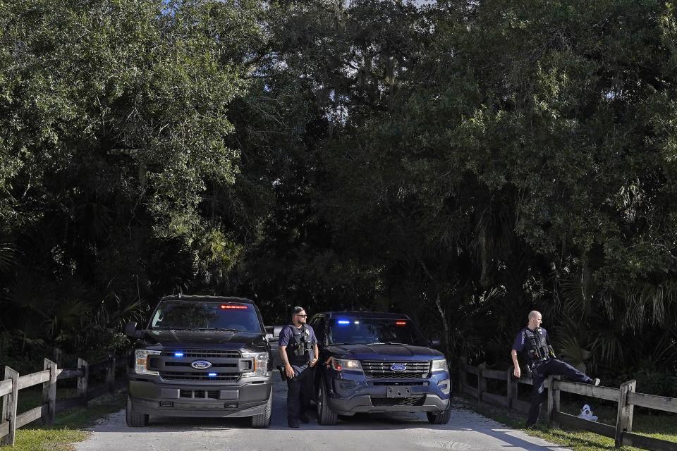 North Port police officers block the entrance to the Myakkahatchee Creek Environmental Park Wednesday, Oct. 20, 2021, in North Port, Fla.