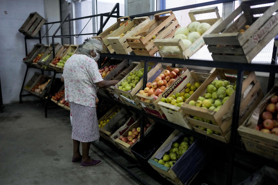 A woman shops for produce at a market subsidized by the municipality so that residents can buy at lower prices amid rising inflation, in Lomas de Zamora, Argentina, Thursday, March 16, 2023. (AP Photo/Natacha Pisarenko)
