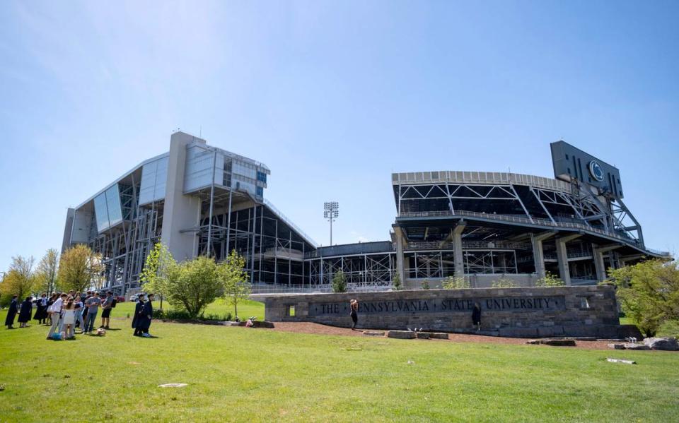 Soon-to-be Penn State graduates line up to take photos at the Pennyslvania State University sign on Wednesday, May 1, 2024. Abby Drey/adrey@centredaily.com