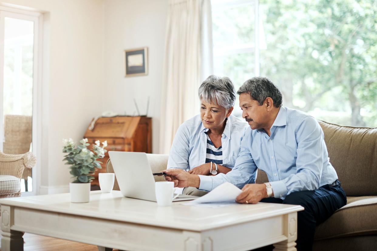 senior couple in living room doing finances