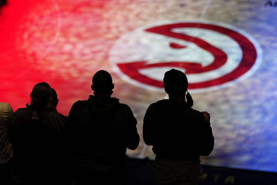 Atlanta Hawks fans stand for the national anthem before an NBA basketball game against the Philadelphia 76ers, Monday, Jan. 11, 2021, in Atlanta. (AP Photo/John Bazemore)