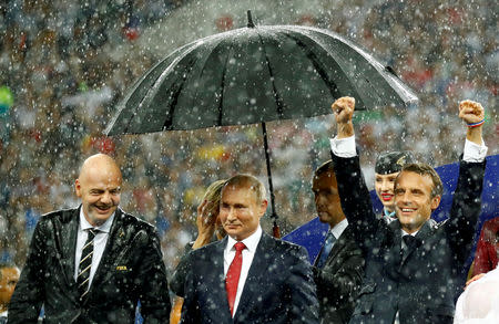 FIFA president Gianni Infantino, President of Russia Vladimir Putin and President of France Emmanuel Macron stand during the presentation during the World Cup at the Luzhniki Stadium in Moscow, Russia, July 15, 2018. REUTERS/Kai Pfaffenbach