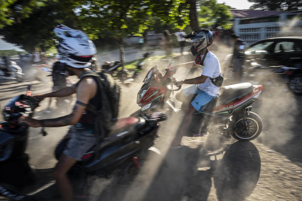 People gather on their electric scooters to spend the late afternoon showing off stunts and racing in Havana, Cuba, Friday, July 15, 2022. Cuba has been flooded in recent years with “motorinas”, as these electric scooters are called on the island, a fad for many, but also a solution to the transportation problems and fuel shortages that overwhelm the Caribbean nation. (AP Photo/Ramon Espinosa)