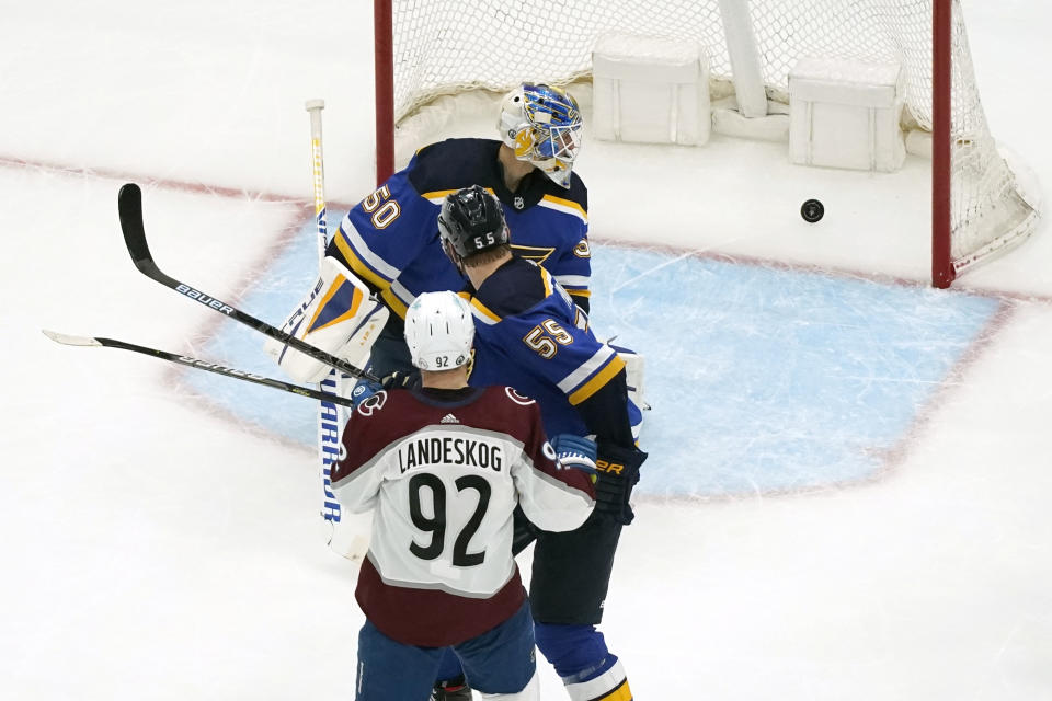 Colorado Avalanche's Gabriel Landeskog (92) scores past St. Louis Blues goaltender Jordan Binnington (50) and Colton Parayko (55) during the second period in Game 4 of an NHL hockey Stanley Cup first-round playoff series Sunday, May 23, 2021, in St. Louis. (AP Photo/Jeff Roberson)