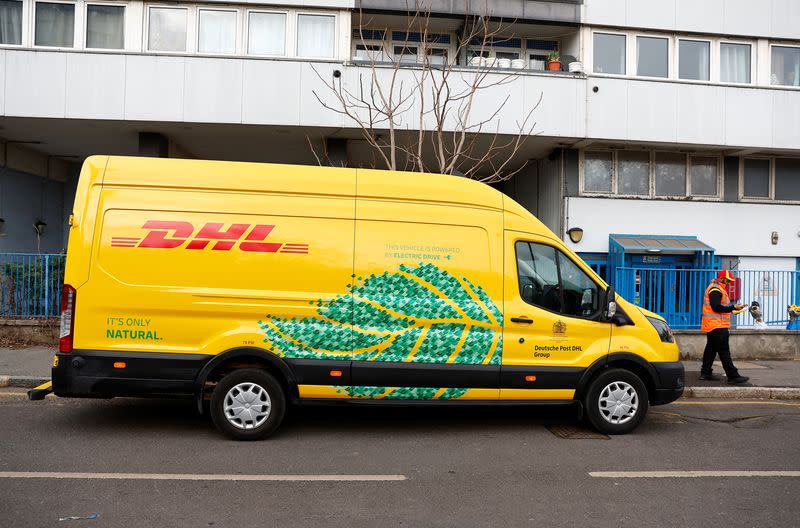 Senior Courier for DHL, Christopher Brownbill, delivers packages from a Ford E-Transit in London