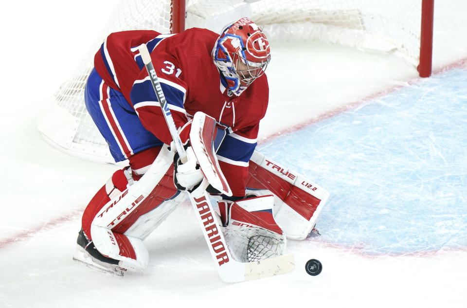 Montreal Canadiens goaltender Carey Price clears the puck during the first period of an NHL Stanley Cup playoff hockey game in Montreal, Sunday, June 6, 2021. (Paul Chiasson/The Canadian Press via AP)