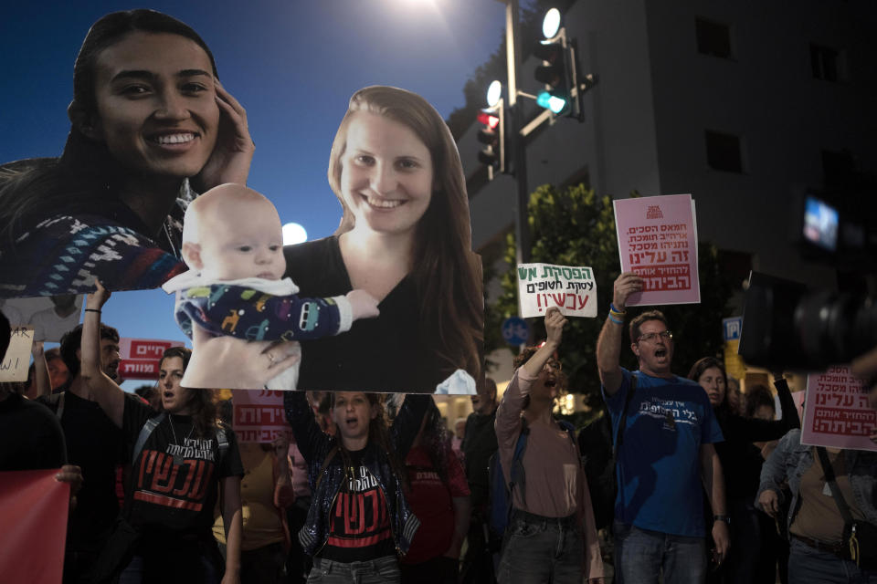 Families and their supporters carry large photos depicting women held hostage by Hamas in the Gaza Strip in a march to call on Israeli Prime Minister Benjamin Netanyahu's government to make a deal to free their loved ones, in Tel Aviv, Israel, Wednesday, May 8, 2024. At center is Shiri Bibas with her child, Kfir; at left is Noa Argamani. (AP Photo/Maya Alleruzzo)