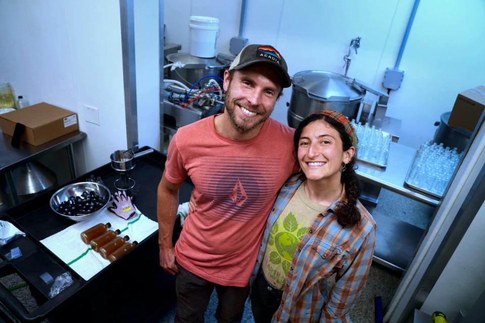 Carissa Wills-DeMello (right) and her husband and partner Adam Davenport of Town Farm Tonics herbal drinks, make tonics from ingredients such as elderberry and more.