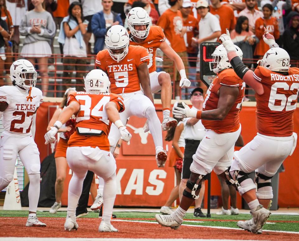 Texas players celebrate a touchdown catch by freshman wide receiver Ryan Wingo, in the air in the foreground, during the Orange-White spring game on April 20. Wingo, a five-star receiver in Texas' 2024 signing class, has jumped out of the gate through his first three games.