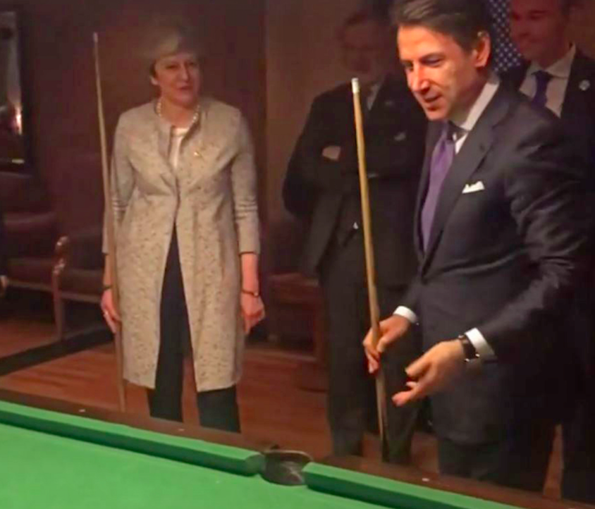 Mrs May was playing pool with Italian leader Giuseppe Conte (Picture: PA)