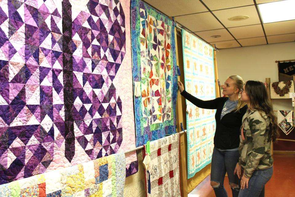 The quilt show hosted by the Meyersdale Volunteer Fire Department during the Pa. Maple Festival has hundreds of classic displays. Here, Grace Oakes, director of the show, and Maddy Faner look at some quilts during last year's show.
