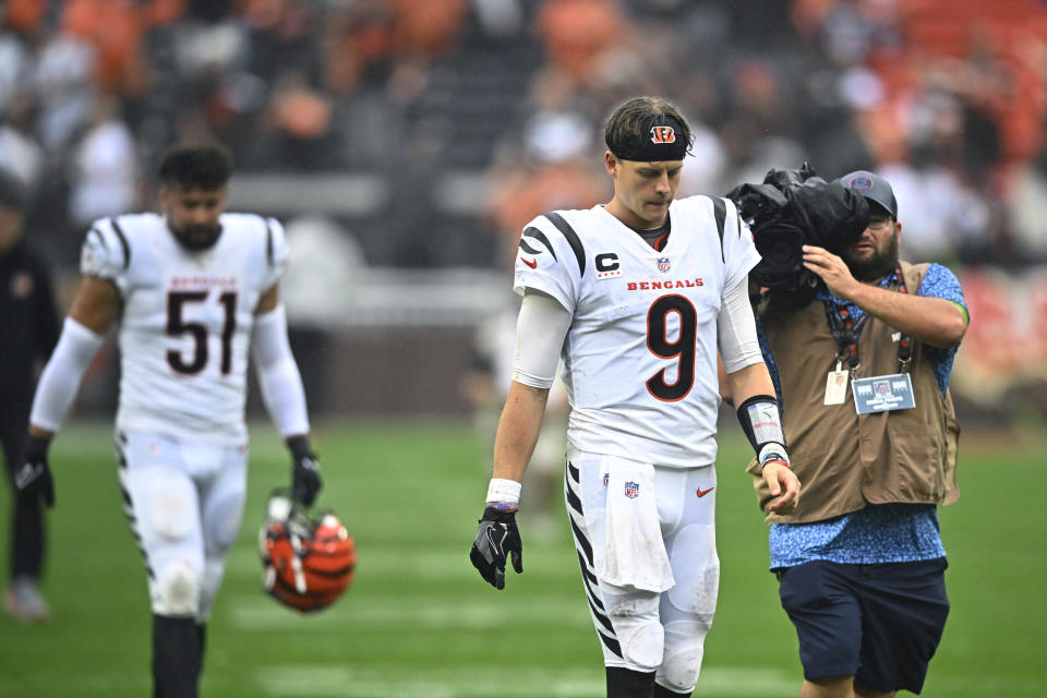 Cincinnati Bengals quarterback Joe Burrow (9) and linebacker Markus Bailey (51) walk off the field after their loss to the Cleveland Browns in an NFL football game Sunday, Sept. 10, 2023, in Cleveland. (AP Photo/David Richard)