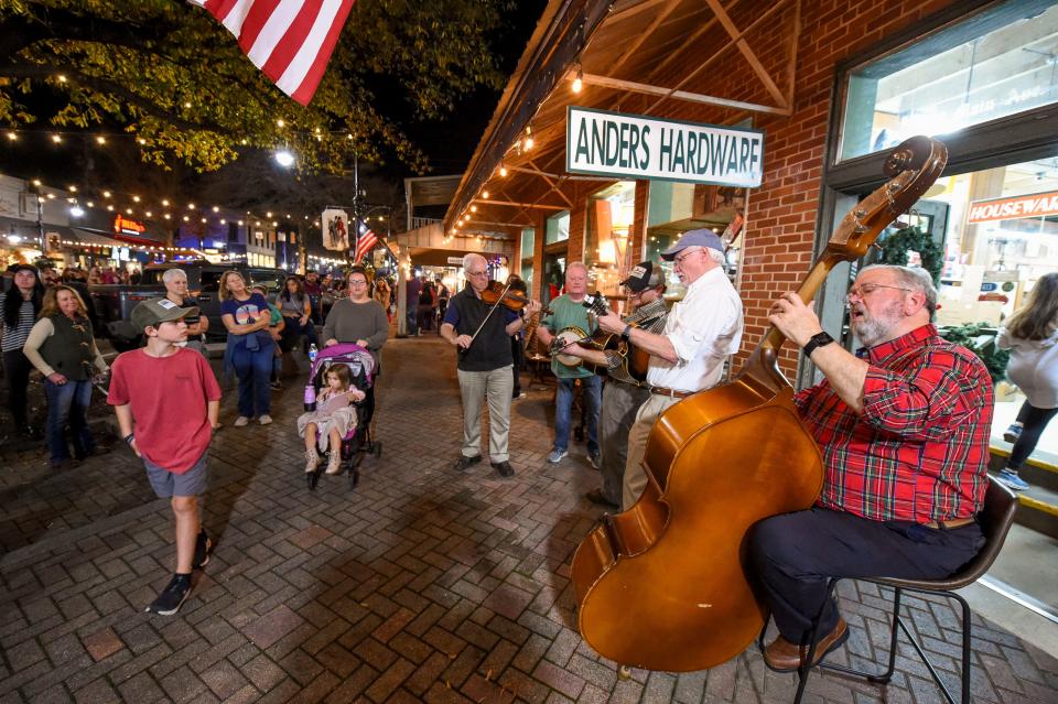 Dec 6, 2022; Tuscaloosa, Alabama, USA;  Northport hosted the annual Dickens Downtown on Main Ave. Tuesday, kicking off the Christmas season. Warrior River Bluegrass Band plays in front of Anders Hardware. 