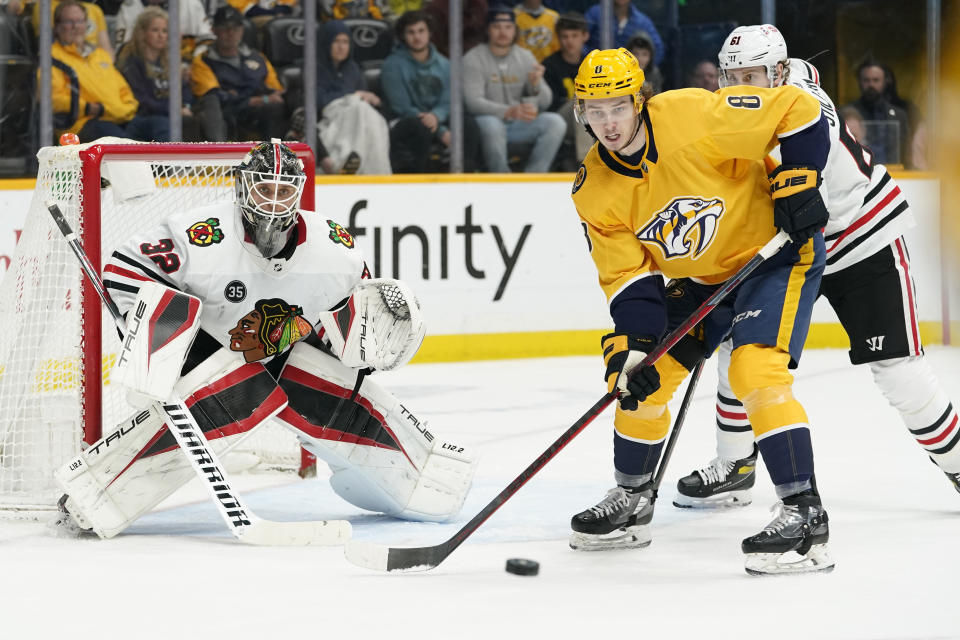 Nashville Predators' Cody Glass (8) reaches for the puck in front of Chicago Blackhawks goaltender Kevin Lankinen (32) in the second period of an NHL hockey game Saturday, April 16, 2022, in Nashville, Tenn. (AP Photo/Mark Humphrey)