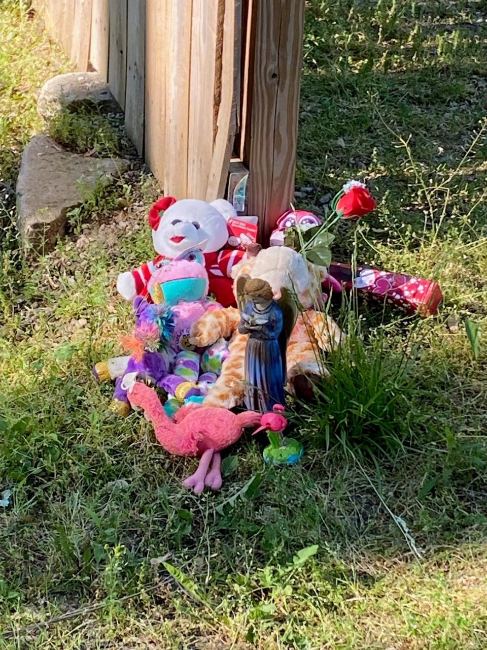 A memorial is set up outside the home in the 1700 block of East Yale Avenue where three people — a 24-year-old man, a 3-year-old boy and a 21-month-old girl — were found dead Sunday. Firefighters found high levels of carbon monoxide in the house.
