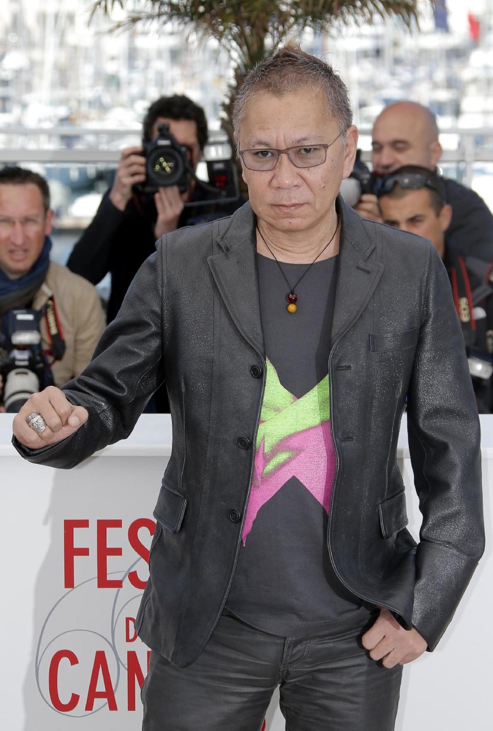 Director Takashi Miike poses for photographers during a photo call for the film Shield of Straw at the 66th international film festival, in Cannes, southern France, Monday, May 20, 2013. (AP Photo/Lionel Cironneau)