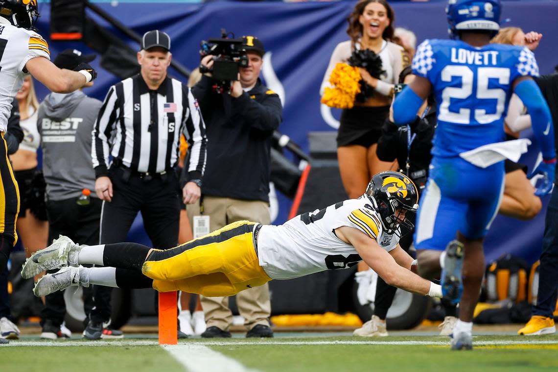 Iowa tight end Steven Stilianos (86) dives into the end zone to score against Kentucky during the Music City Bowl on Saturday.