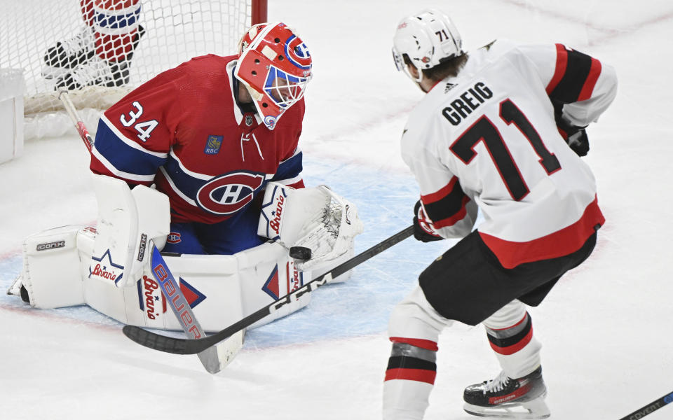 Montreal Canadiens goaltender Jake Allen stops Ottawa Senators' Ridly Greig during the second period of an NHL hockey game in Montreal, Tuesday, Jan. 23, 2024. (Graham Hughes/The Canadian Press via AP)