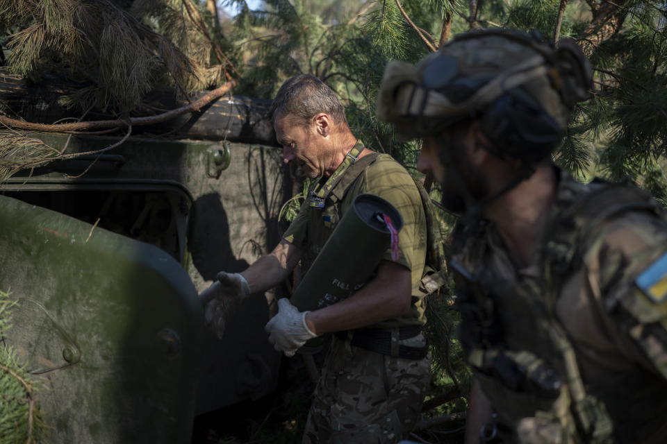 Ukrainian soldiers load a howitzer with a shell on the front line in the outskirts of Lyman, Ukraine, Tuesday, Aug. 15, 2023. Moscow’s army is staging a ferocious push in northeast Ukraine designed to distract Ukrainian forces from their counteroffensive and minimize the number of troops Kyiv is able to send to more important battles in the south. (AP Photo/Bram Janssen)