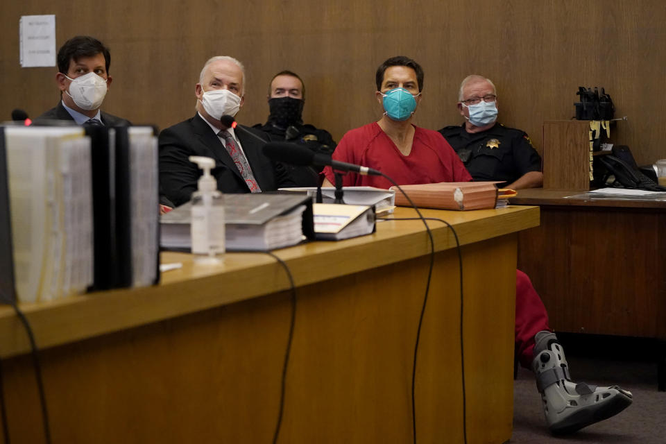 Scott Peterson, foreground right, sits with his attorneys, Andras Farkas, left, and Pat Harris, second from left, at the San Mateo County Superior Court in Redwood City, Calif., Thursday, Aug. 11, 2022. Peterson is in court for a hearing to determine whether he gets a new trial in the murder of his pregnant wife because of juror misconduct. (AP Photo/Jeff Chiu, Pool)