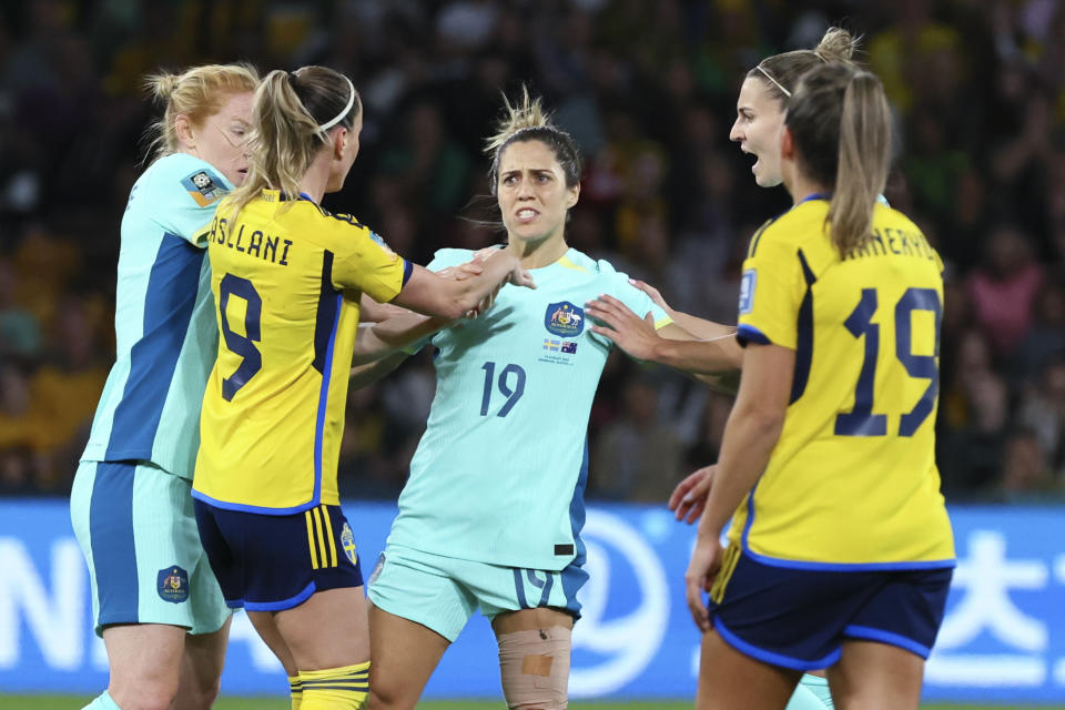 Australia's Katrina Gorry, centre, is separated by teammates from Sweden's Kosovare Asllani during the Women's World Cup third place playoff soccer match between Australia and Sweden in Brisbane, Australia, Saturday, Aug. 19, 2023. (AP Photo/Tertius Pickard)