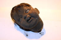 <p>This doll head was found in the northeast fireplace in the basement of 97 Orchard St. in 2012. (Photo: Caters News) </p>