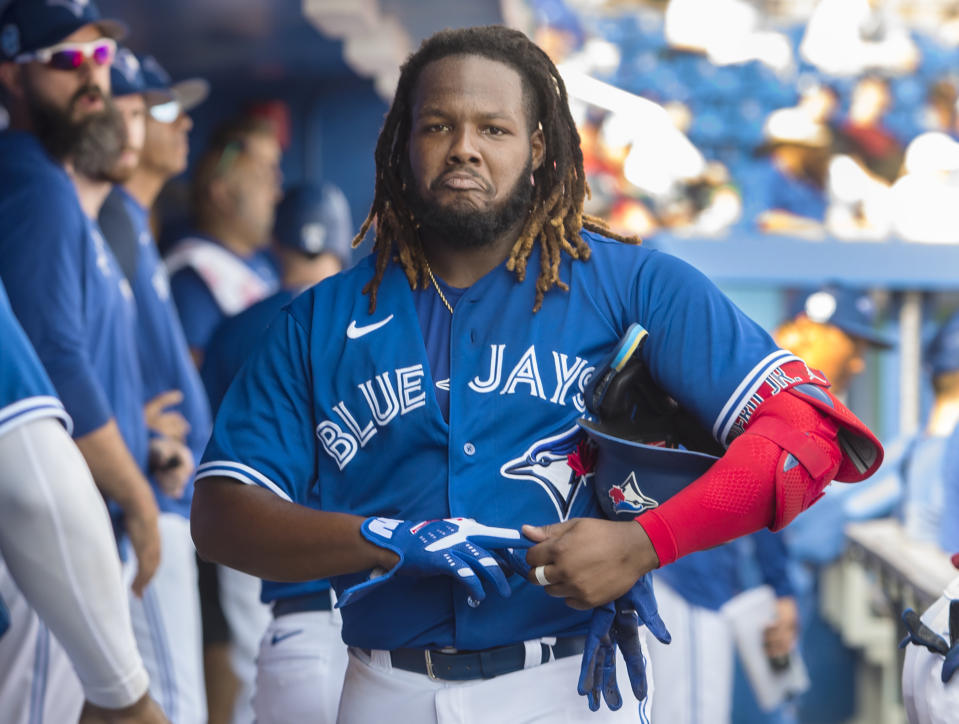 Toronto Blue Jays' Vladimir Guerrero takes off his batting gloves after his three plate appearances in a spring training baseball game against the Pittsburgh Pirates in Dunedin, Fla., Thursday, March 2, 2023. (Fred Thornhill/The Canadian Press via AP)