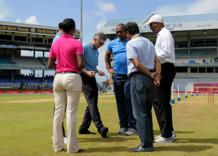 Umpire Nigel Llong (2L) illustrates a point to West Indies head coach Phil Simmons (3L) while inspecting the field on day 4 of the fourth and final Test between West Indies and India at Queen's Park Oval in Port of Spain, Trinidad August 21, 2016