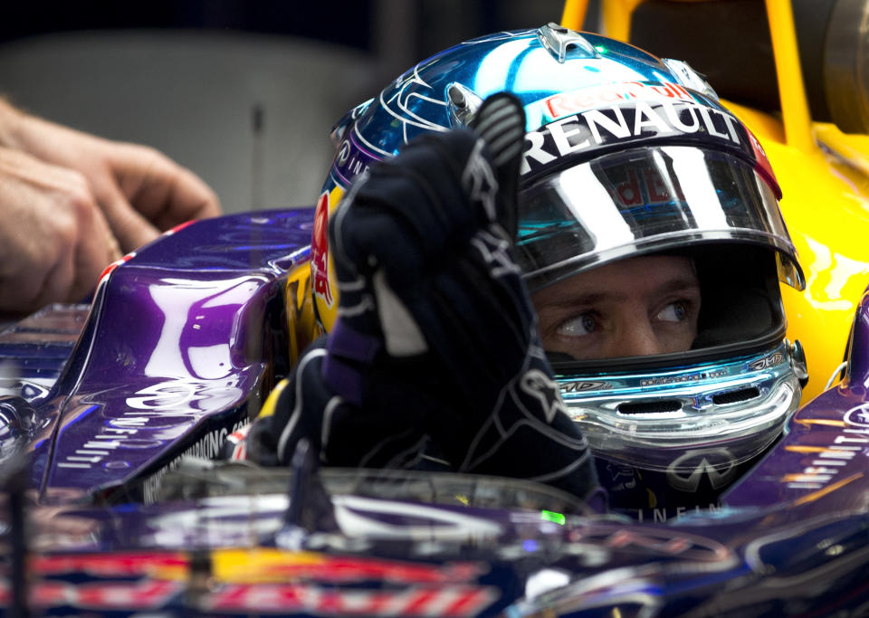 Red Bull driver Sebastian Vettel prepares for his practice session ahead of Sunday's Chinese Formula One Grand Prix at Shanghai International Circuit in Shanghai, China Friday, April 18, 2014. (AP Photo/Andy Wong)