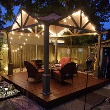 a reviewer photo of an outdoor gazebo with string lights along the edges 