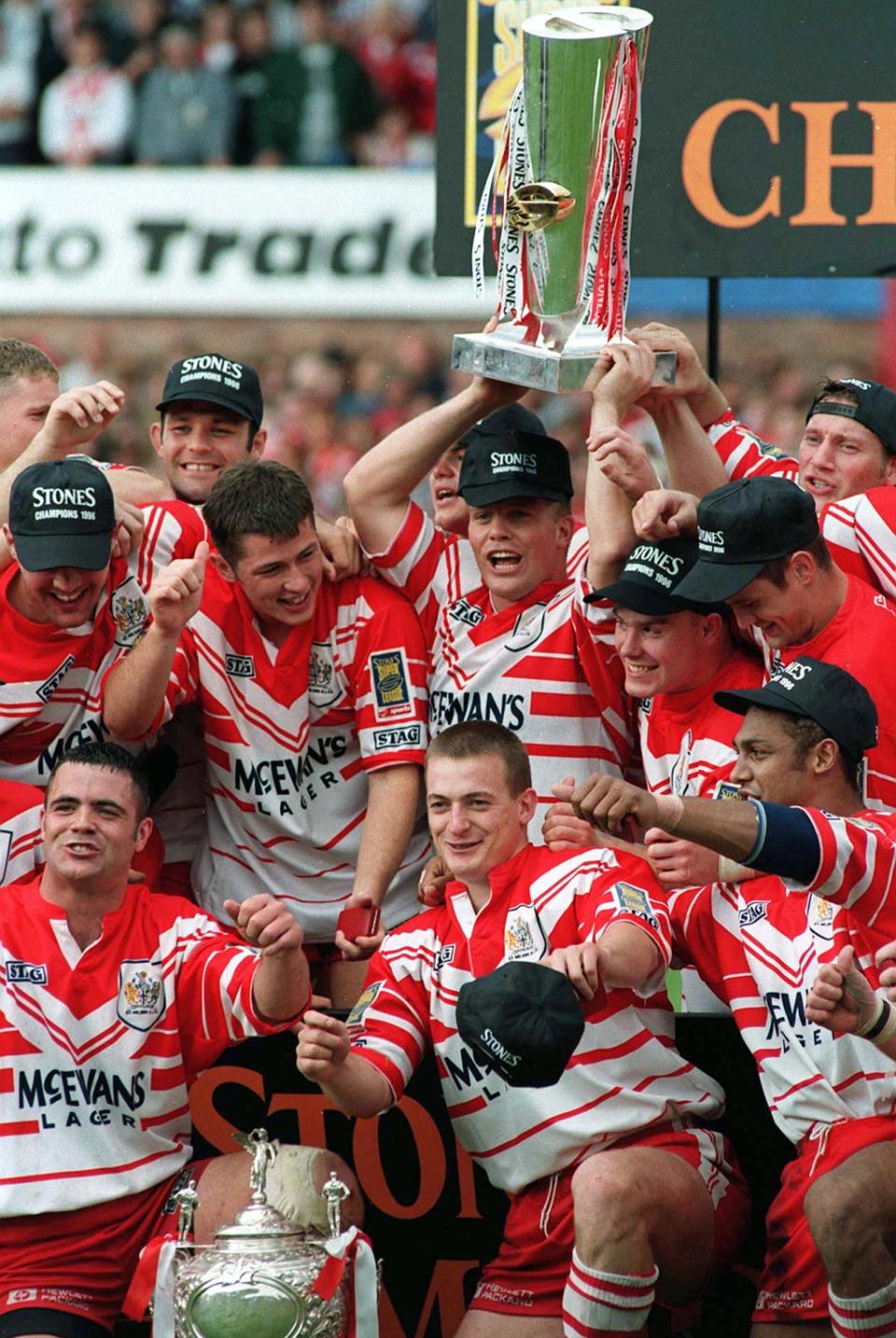 Bobbie Goulding, holding the trophy, celebrates with team-mates after St Helens won the 1996 Challenge Cup final (PA)