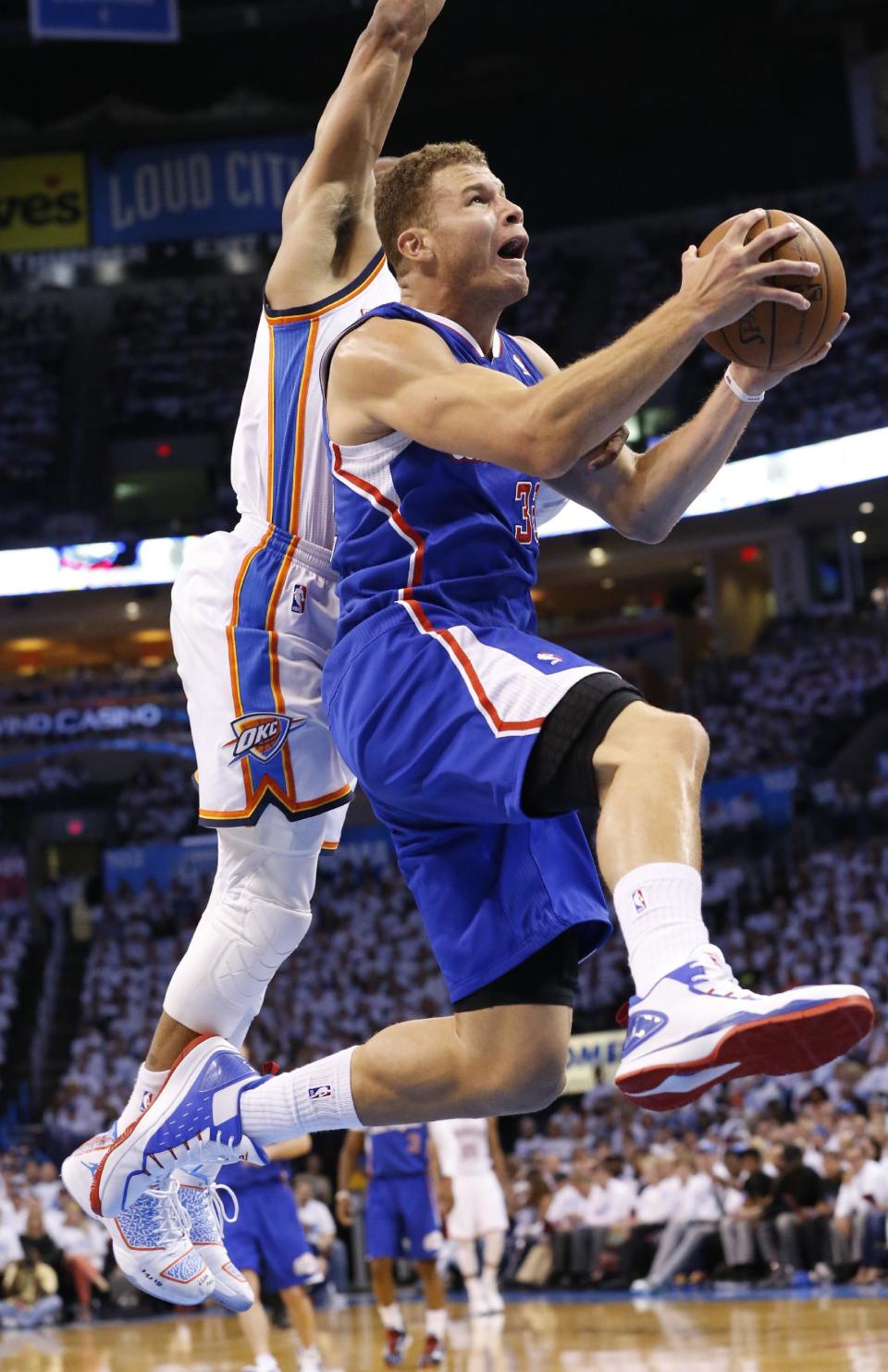 Los Angeles Clippers forward Blake Griffin (32) is fouled by Oklahoma City Thunder guard Russell Westbrook as he goes up for a shot in the first quarter of Game 5 of the Western Conference semifinal NBA basketball playoff series, in Oklahoma City, Tuesday, May 13, 2014. (AP Photo)