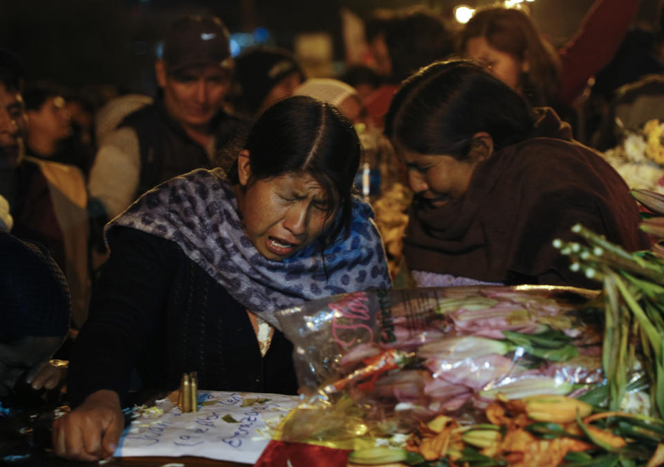 Women mourn over the coffin of a supporter of former President Evo Morales killed during clashes with security forces in Sacaba, Bolivia, Friday, Nov. 15, 2019. Bolivian security forces clashed with Morales' backers leaving at least five people dead, dozens more injured and escalating the challenge to the country's interim government to restore stability. (AP Photo/Juan Karita)