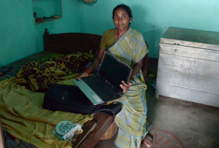 Silkworm farmer Munia Murmu shows off her new laptop at her home in the Banka district of the eastern state of Bihar, on August 6, 2015