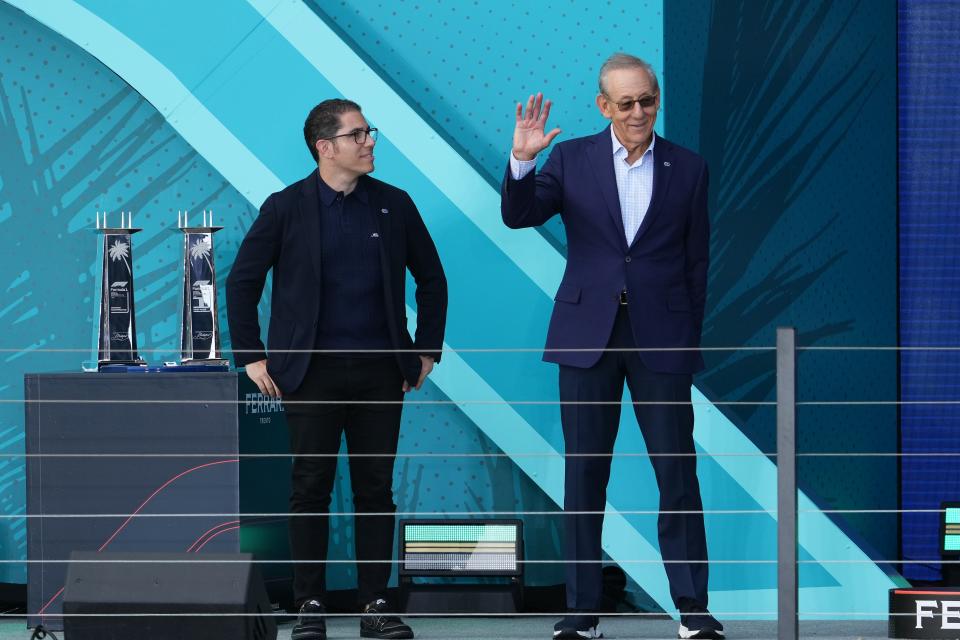 Miami Dolphins owner Stephen M. Ross (right) reacts before awarding trophies on the podium following the Miami Grand Prix at Miami International Autodrome.