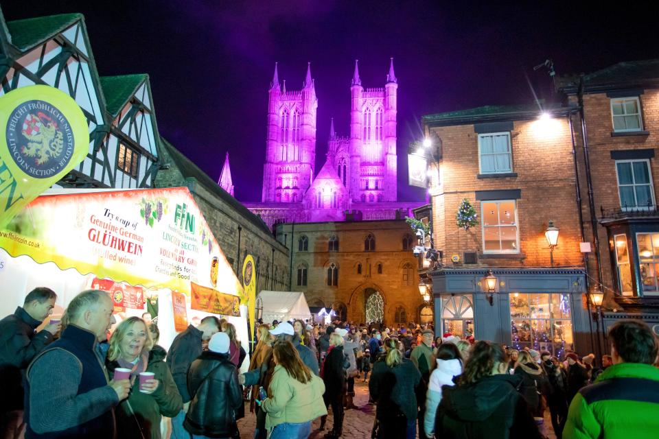 Lincoln Cathedral is floodlit for the annual Christmas market. Visitors pack the maarket between the Cathedral and the castle..The market returning after being cancelled the previous year due to Covid 19 is one of the largest Christmas markets in Europe. Centred in and around the catle and the Cathedral in the Bailgate area of Lincoln the markets draws visitors from all over Europe.