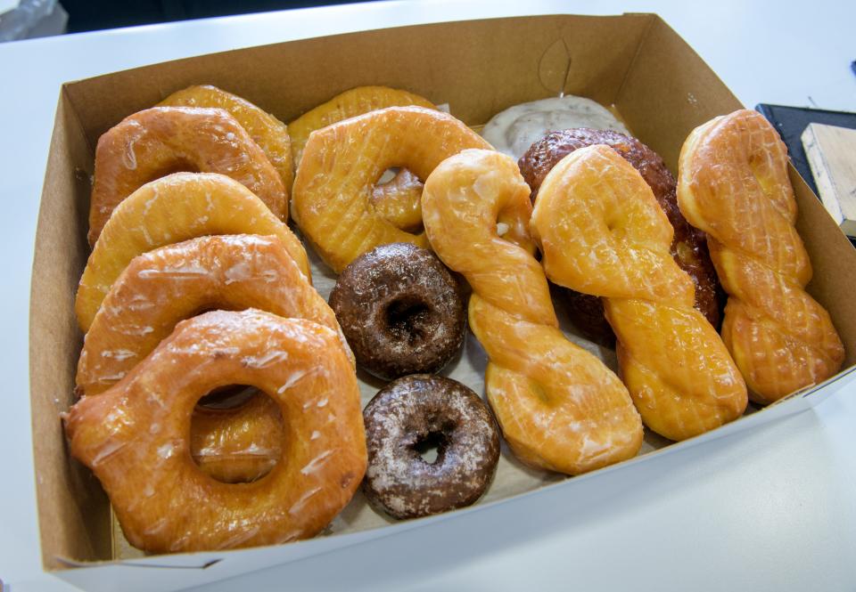 Freshly-made doughnuts are boxed up and ready for a customer at Tadoughs in Pekin.