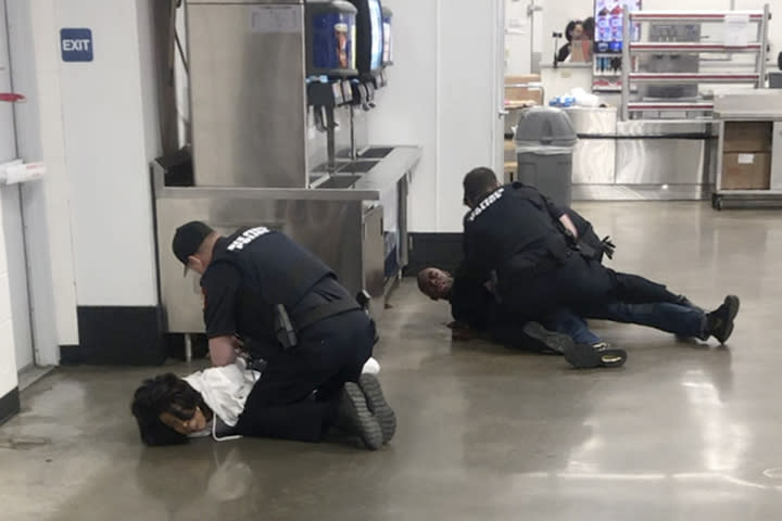 FILE - In this March 23, 2020, file frame grab taken from video, Marvia Gray, left and her son Derek Gray are arrested by white police officers at a Sam's Club store in Des Peres, Missouri. St. Louis County’s prosecutor launched of an investigation Wednesday, May 20, 2020, after video showed white police officers forcefully arresting Gray and her son Derek. (Photo courtesy Action Injury Law Group via AP, File)