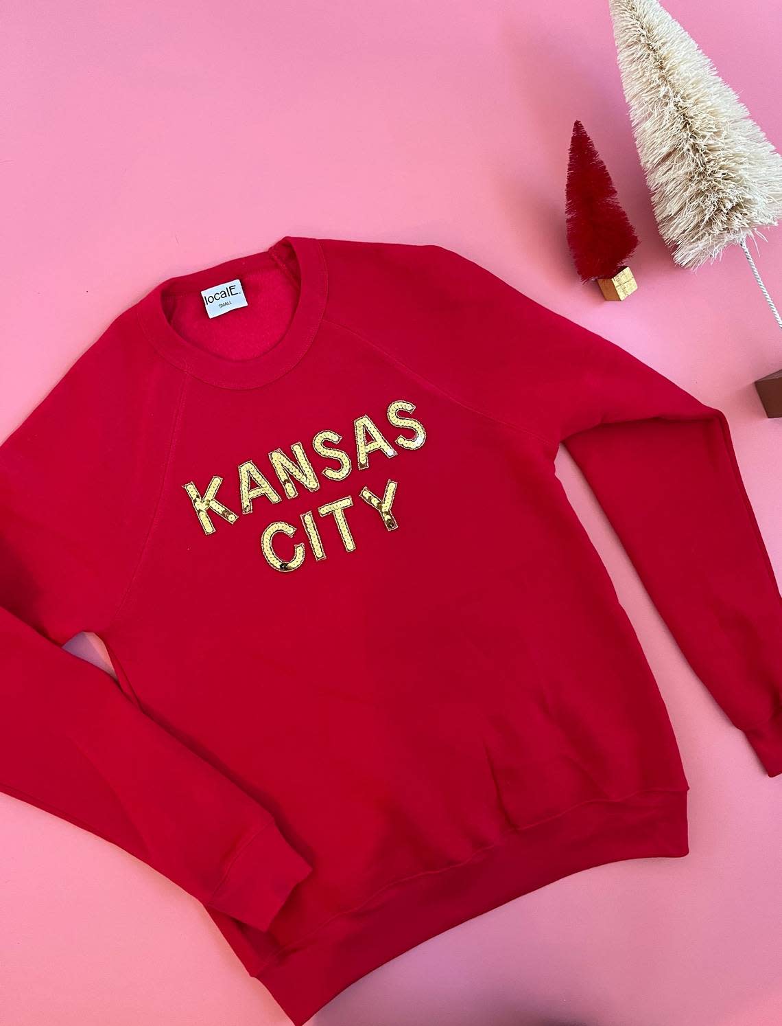 A sequined Kansas City sweatshirt is a bestselling gift item from LocalE, an local brand specializing in game day apparel.