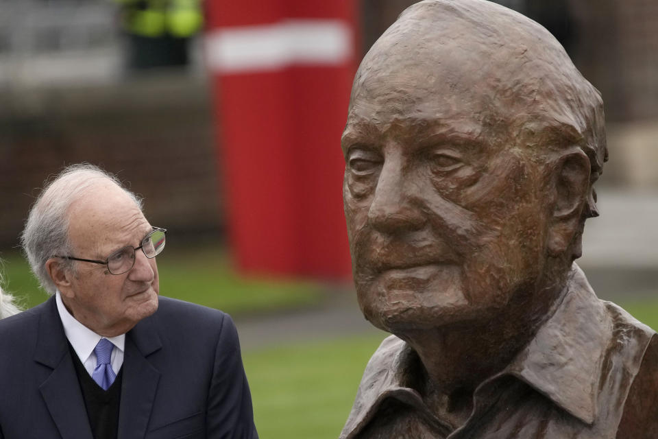 Former U.S. Sen. George Mitchell looks at his bust during the unveiling on the first day of a three-day international conference at Queen's University Belfast to mark the 25th anniversary of the Good Friday Agreement, in Belfast, Northern Ireland, Monday, April 17, 2023. Former U.S. President Bill Clinton and past leaders of the U.K. and Ireland are gathering in Belfast on Monday, 25 years after their charm, clout and determination helped Northern Ireland strike a historic peace accord. (AP Photo/Christophe Ena)