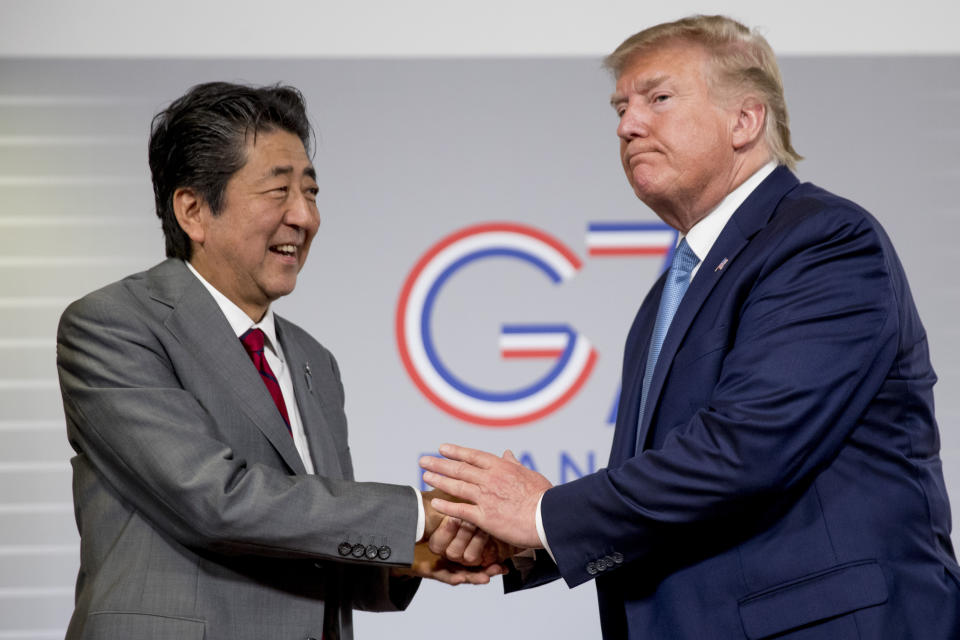 FILE - In this Aug. 25, 2019, file photo, U.S President Donald Trump and Japanese Prime Minister Shinzo Abe shake hands following a news conference at the G-7 summit in Biarritz, France to announce that the U.S. and Japan have agreed in principle on a new trade agreement. On Tuesday, Sept. 17, 2019, officials in Japan appear wary over the prospects for a trade deal with the U.S. after President Donald Trump said he was prepared to sign a pact soon. (AP Photo/Andrew Harnik, File)