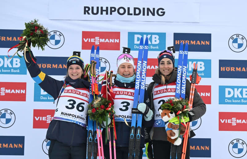 (L-R) Second placed Sweden's Mona Brorsson, winner Norway's Ingrid Landmark Tandrevold and third placed Italy's Lisa Vittozzi celebrate on the podium after the Women's 7.5km sprint event of the IBU Biathlon World Cup in Ruhpolding. Sven Hoppe/dpa