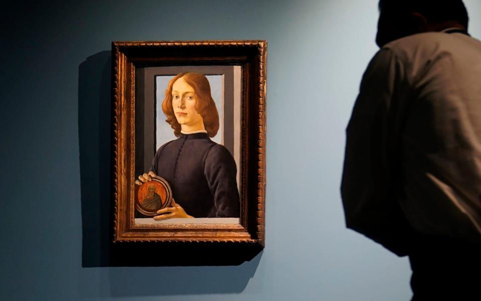 The attribution of Sandro Botticelli's 15th-century painting, Young Man Holding a Roundel, has been disputed by several analysts - AP Photo/Seth Wenig