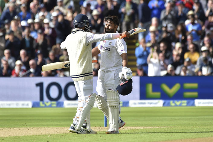 India's Rishabh Pant, right, celebrates with batting partner Ravindra Jadeja after scoring a century during the first day of the fifth cricket test match between England and India at Edgbaston in Birmingham, England, Friday, July 1, 2022. (AP Photo/Rui Vieira)
