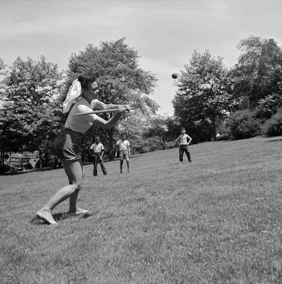 <p>Eartha Kitt looks casual during a day in the park in 1952. The singer joined a game of softball for fun. </p>