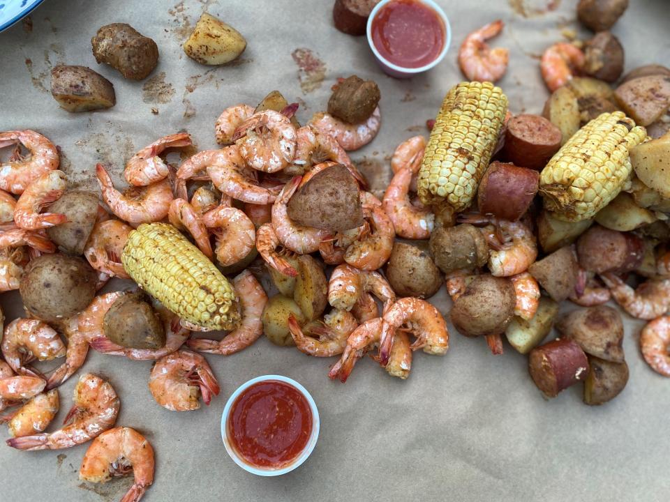 The Low Country Shrimp Bay Bucket from Topsail Steamers in Ship Bottom has shrimp, andouille sausage, corn, potatoes and seasonings. Cocktail sauce, butter and paper for serving are included.