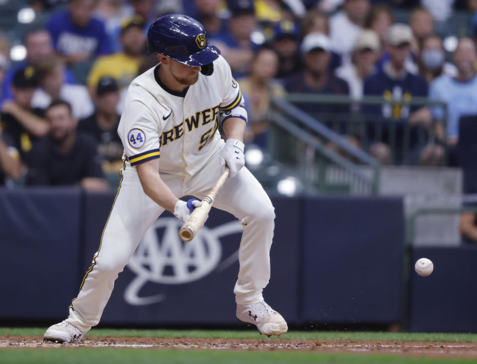 Milwaukee Brewers starting pitcher Eric Lauer bunts for a base hit against the Pittsburgh Pirates during the third inning of a baseball game Monday, Aug. 2, 2021, in Milwaukee. (AP Photo/Jeffrey Phelps)
